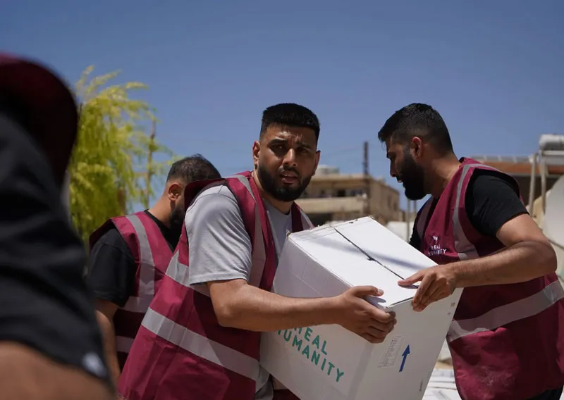 Smiling children receiving humanitarian aid